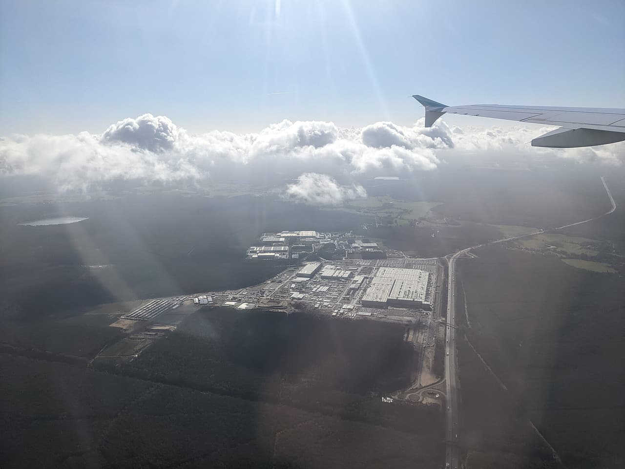 Aerial view of the Tesla Gigafactory Berlin-Brandenburg site from an aircraft window