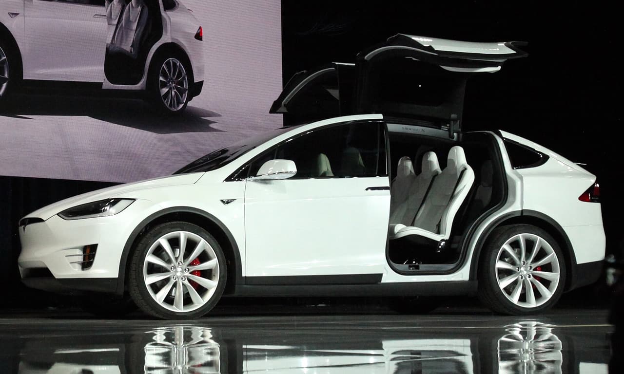 White Tesla Model X with its falcon-wing doors open