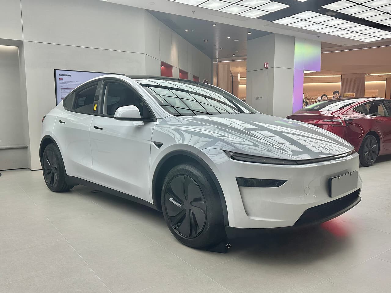 White facelifted Tesla Model Y in a showroom